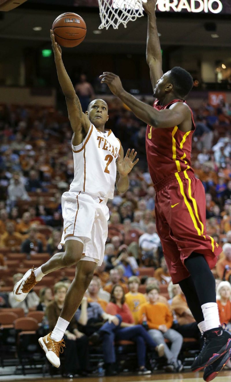 Texas' Demarcus Holland (2) shoots over Iowa State's Melvin Ejim, right, during the first half on an NCAA college basketball game, Saturday,  Jan. 18, 2014, in Austin, Texas. (AP Photo/Eric Gay)
