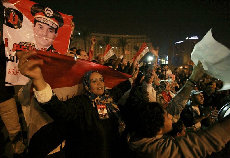 Holding national flags and portraits of military chief  Gen. Abdel-Fattah el-Sissi, Egyptians celebrate the passage of a new constitution after 98.1 percent of voters supported Egypt's military-backed constitution in a two-day election, in Tahrir Square, Cairo, Egypt, Saturday, Jan. 18, 2014. In the lead up to the vote, police arrested those campaigning for a "no" vote on the referendum, leaving little room for arguing against the document. (AP Photo/El Shorouk Newspaper, Sabry Khaled)  EGYPT OUT
