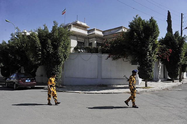 Yemeni soldiers stand guard in front of the Iranian ambassador's residence in Sanaa, Yemen, Saturday, Jan. 18, 2014. Iranian state television announced that Ali Asghar Asadi, Iran's economic attache in Sanaa, was "martyred." (AP Photo/Hani Mohammed)