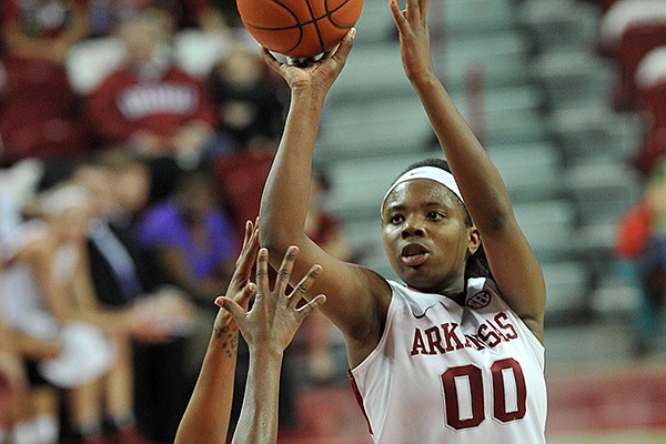 Arkansas forward Jessica Jackson drives to the hoop past Ole Miss defender Tia Faleru in the first half of Sunday afternoon's game at Bud Walton Arena in Fayetteville.
