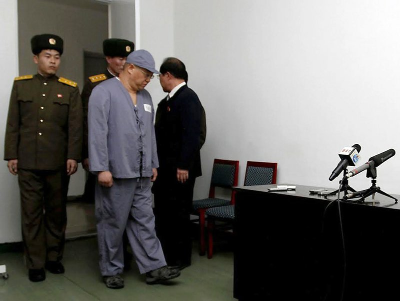 American missionary Kenneth Bae, second from right, arrives to speak to reporters at Pyongyang Friendship Hospital in Pyongyang on Monday, Jan. 20, 2014. Bae, 45, who has been jailed in North Korea for more than a year, appealed for the U.S. to do its best to secure his release. 