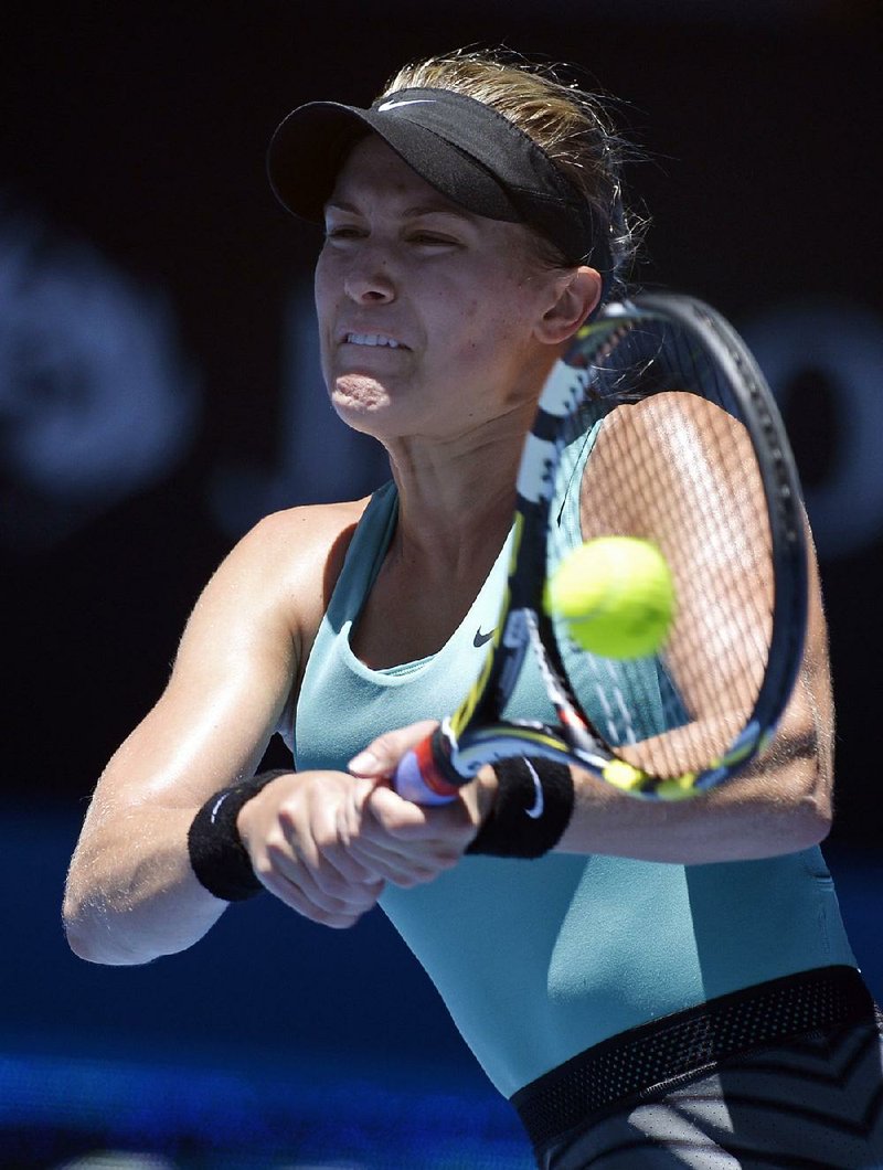 Eugenie Bouchard of Canada makes a backhand return to Ana Ivanovic of Serbia during their quarterfinal at the Australian Open tennis championship in Melbourne, Australia, Tuesday, Jan. 21, 2014. (AP Photo/Andrew Brownbill)