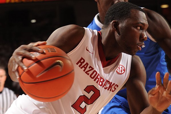 Arkansas forward Alandise Harris (2) drives to the basket past Kentucky forward Julius Randle during the first half of play Tuesday, Jan. 14, 2014, in Bud Walton Arena in Fayetteville.