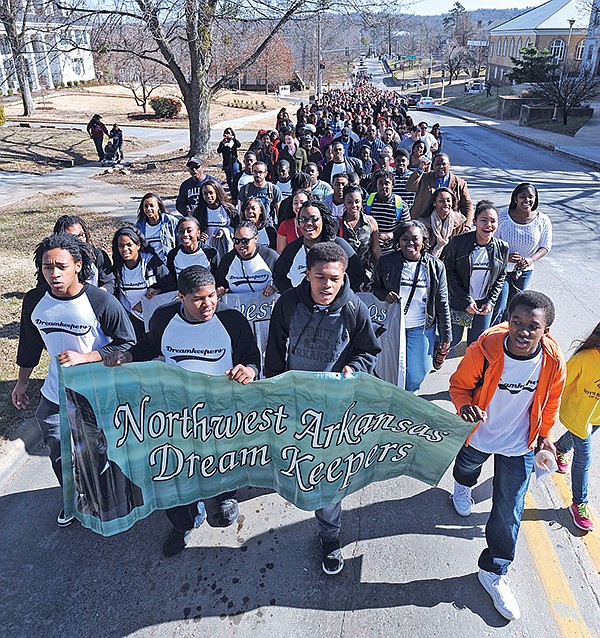STAFF PHOTOS ANDY SHUPE 
Marchers make their way up Maple Street during the annual march Monday in honor of Martin Luther King Jr. in Fayetteville.