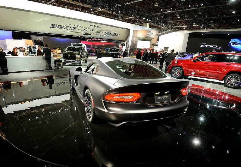 A Chrysler Group LLC SRT Viper is displayed last week at the 2014 North American International Auto Show in Detroit. Fiat SpA on Tuesday took full control of Chrysler in the U.S., and the Italian car maker’s board will meet next Wednesday to lay out terms for merging the two firms. 