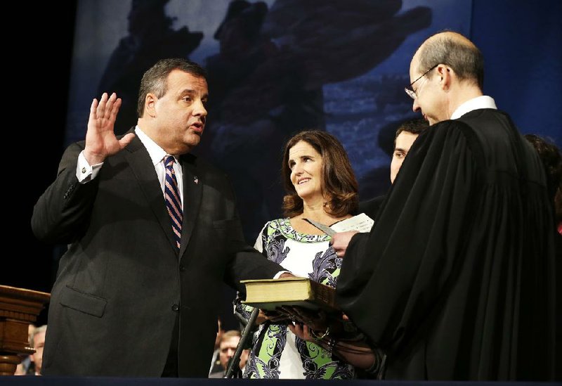 As wife Mary Pat Christie holds the Bible, New Jersey Gov. Chris Christie is sworn in Tuesday for his second term by New Jersey Supreme Court Chief Justice Stuart Rabner in Trenton, N.J. 