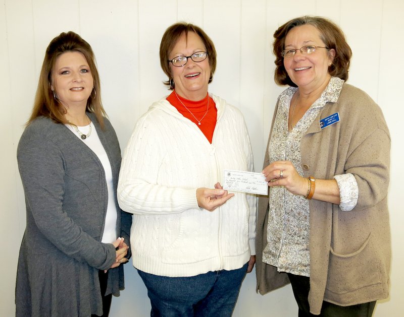 Photo by Randy Moll Lonnie Moll, president of the Gentry Lions Club, presents a check for $1,500 from the Lions Club to the Gentry School District. Receiving the check is Myra Welch, special education secretary for the district, and Angie Dennis, special education director. The check was to pay for half the cost of a VisioBook to assist a vision-impaired student at the intermediate school.