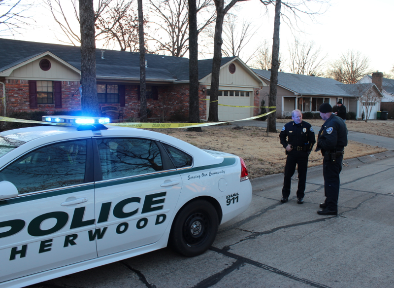 Sherwood police work the scene of a domestic disturbance where officers shot a man who was armed with two handguns, authorities said.