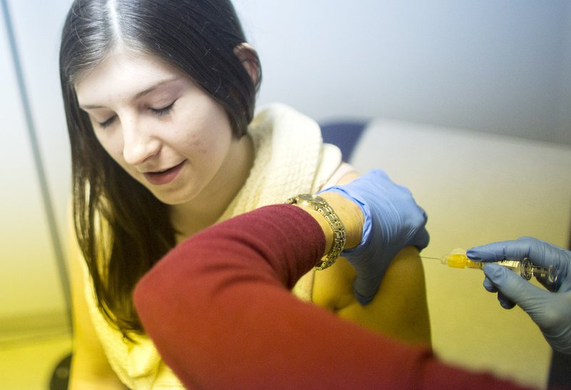 Kristena Merritt, a student at the University of Arkansas at Little Rock, receives a free flu shot from Renee Jorgensen on Jan. 16. The campus advertised a special three hours of free flu shots at its health-services clinic.