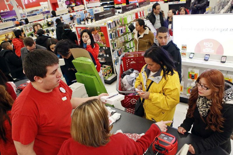 Customers wait to check out at a Target Corp. store in Chicago on Thanksgiving Day. Hackers stole about 40 million debit and credit card numbers from cards swiped at Target stores between Nov. 27 and Dec. 15, the company says. 