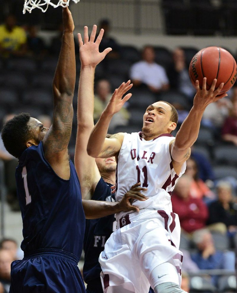 Junior guard DeVonte Smith (right) is averaging 3.9 points and 2.9 rebounds per game for UALR this season. 