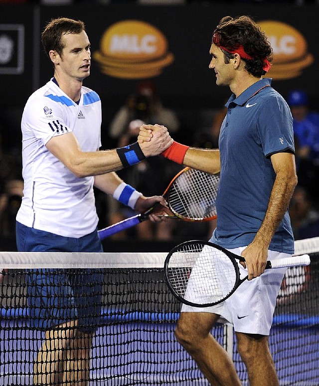 Roger Federer of Switzerland (right) shakes hands with Britain’s Andy Murray at the net following Federer’s 6-3, 6-4, 6-7 (6), 6-3 quarterfinal victory over Murray at the Australian Open in Melbourne, Australia. Federer advances to face top-seeded Rafael Nadal in the semifinals. 