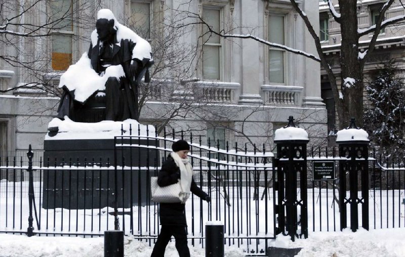 Snow covers a statue of Horace Greeley on Wednesday in New York’s City Hall Park. 