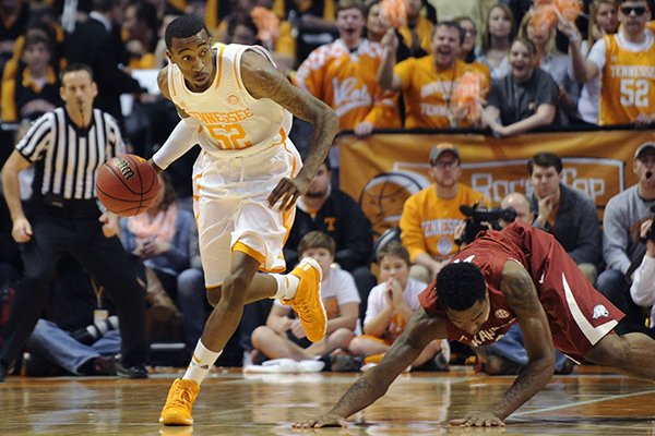 Tennessee guard Jordan McRae (52) beats Arkansas forward Coty Clarke (4) to a rebound during the first half of an NCAA college basketball game in Knoxville, Tenn., on Wednesday, Jan. 22, 2014. Tennessee won 81-74. (AP Photo/Knoxville News Sentinel, Adam Lau)