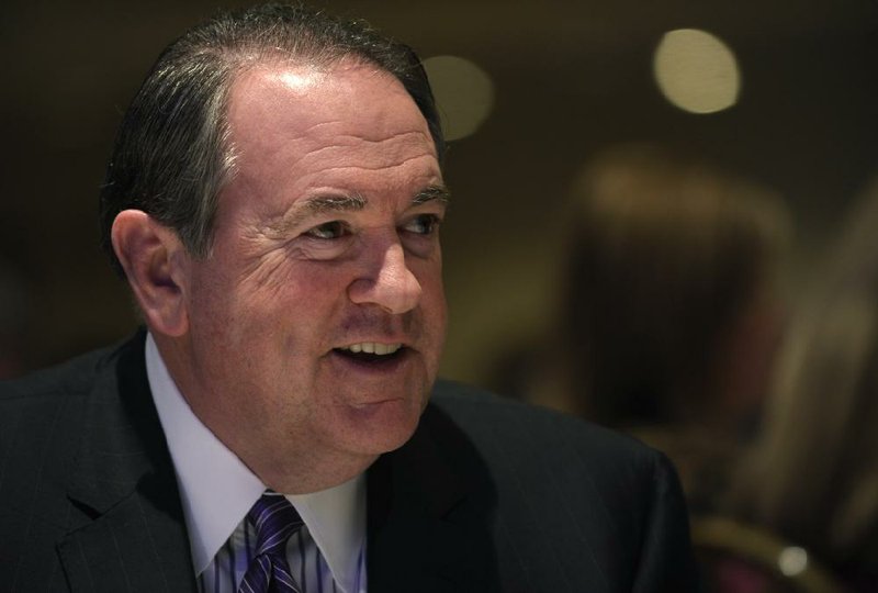 Former Arkansas Gov. Mike Huckabee sits down for lunch before speaking at the Republican National Committee winter meeting in Washington, Thursday, Jan. 23, 2014. (AP Photo/Susan Walsh)