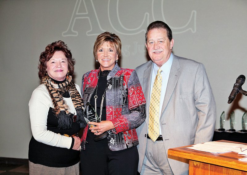Janis Walmsley, secretary of the Arkansas Board of Corrections, left, and Dan Roberts, deputy director of the ACC Parole/Probation Services, right, present Jana Vinson, assistant area manager for Area 3 of the ACC Parole/Probation Services, center, with an ACC Gold Key Award. Vinson has worked with the ACC since 1989.
