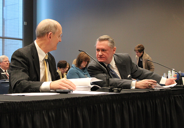 UA Chancellor G. David Gearhart, right, addresses the board of trustees Friday alongside Don Pederson, UA Vice Chancellor for Finance and Administration, shortly after the board voted for a resolution in support of Gearhart.