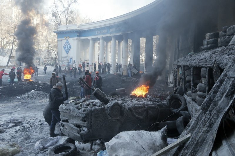 Protesters guard the barricades near the entrance to the stadium of Dynamo Kyiv soccer club in Kiev, Ukraine, on Friday, Jan. 24, 2014. 