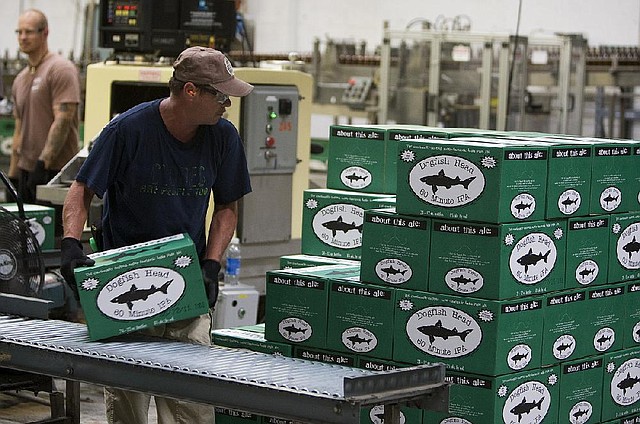 Employees work on the bottling line at Dogfish Head Craft Brewery Inc. facility in Milton, Del. Craft-beer sales grew 16 percent in volume over the past year, while sales of the biggest U.S. beer brands fell 1.7 percent, according to researcher Symphony IRI Group. 