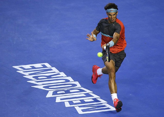Rafael Nadal of Spain hits a forehand return to Roger Federer of Switzerland during their semifinal at the Australian Open tennis championship in Melbourne, Australia, Friday, Jan. 24, 2014.(AP Photo/Aijaz Rahi)