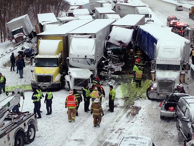 In this photo provided by the Indiana State Police, emergency crews work at the scene of a massive pileup involving more than 40 vehicles, many of them semitrailers, along Interstate 94, Thursday afternoon, Jan. 23, 2014, near Michigan City, Ind. At least three were killed and more than 20 people were injured. (AP Photo/Indiana State Police)
