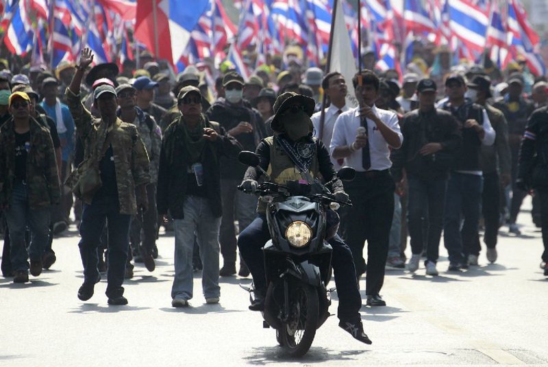 A motorcyclist leads a march of anti-government protesters during a rally Friday, Jan. 24, 2014 in Bangkok. Thailands Constitutional Court ruled Friday that nationwide elections scheduled for Feb. 2 can legally be delayed. (AP Photo/Wason Wanichakorn)