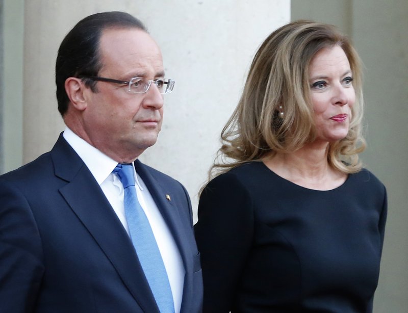 FILE - In this Sept. 3, 2013 file photo, French president Francois Hollande and his companion Valerie Trierweiler wait for German President Joachim Gauckand, at the Elysee Palace, in Paris. (AP Photo/Jacques Brinon, File)