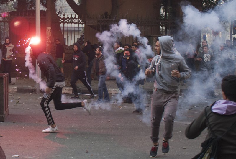 Egyptian anti-military protesters, mostly supporters of ousted Islamist President Mohammed Morsi, clash with security forces in downtown Cairo, Egypt, Saturday, Jan. 25, 2014. Security forces also moved to shut down rallies marking the anniversary by secular youth activists who led the 2011 anti-Mubarak uprising and who are critical of both the Islamists and the military. A number of their most prominent figures have been in prison for months amid a campaign to silence even secular voices of dissent. (AP Photo/Ahmed Ashraf)