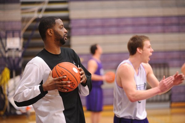 Former Fayetteville High and Kansas player Nick Bradford helps FHS players during a shooting drill Wednesday, Jan. 19, 2011, during practice at Fayetteville High. Bradford is back in Fayetteville after stints playing overseas in Romania, Iceland, France and Finland.