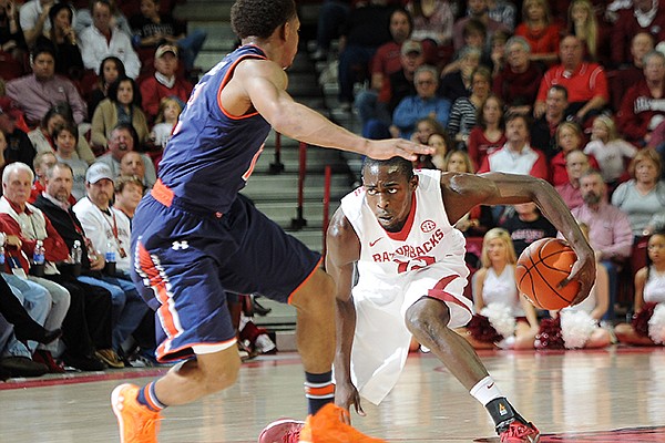 Arkansas' Fred Gulley gets low to regain balance after fighting with Auburn's Tahj Shamsid-Deen for a ball loose in the air Saturday, Jan. 25, 2014, during the second half of the game against Auburn at Bud Walton Arena in Fayetteville.