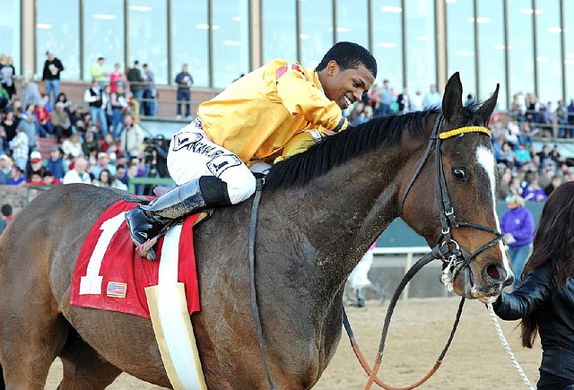 Jockey Ricardo Santana Jr. celebrates Saturday after winning the American Beauty Stakes with Apropos at Oaklawn Park in Hot Springs. 