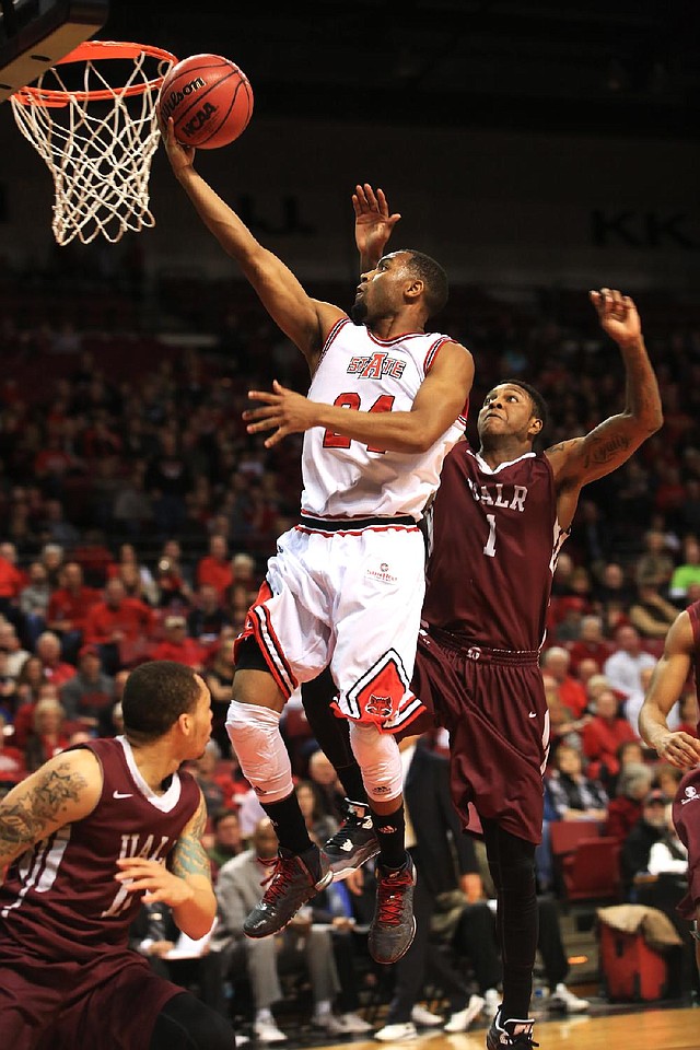 Arkansas State’s Ed Townsel drives past UALR’s Leroy Isler in the first half of the Red Wolves’ 77-49 victory in Jonesboro on Saturday. Townsel had nine points and nine rebounds in the game. 