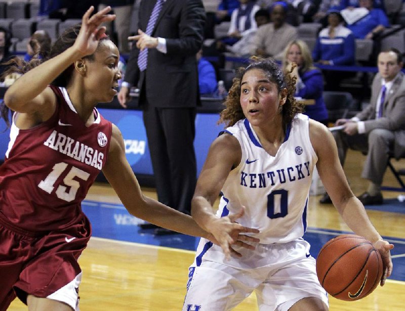 Kentucky's Jennifer O'Neill (0) looks for an opening while Arkansas' Kelsey Brooks (15) defends during the second half of NCAA college basketball game, Sunday, Jan. 26, 2014, in Lexington, Ky. Kentucky won 68-58. (AP Photo/James Crisp)