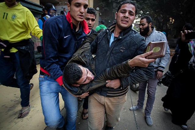 Protesters supporting ousted Egyptian leader Mohammed Morsi carry an injured demonstrator to safety Saturday after clashes with police in Cairo. 