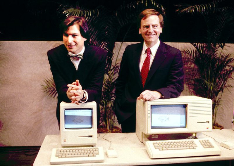 FILE -This January 1984, file photo, shows Steven P. Jobs, left and John Sculley presenting the new Macintosh Desktop Computer in January 1984 at a shareholder meeting in Cupertino, Calif. January 24, 2014, marks thirty years after the first Mac computer was introduced, sparking a revolution in computing and in publishing as people began creating fancy newsletters, brochures and other publications from their desktops. (AP Photo/FILE)