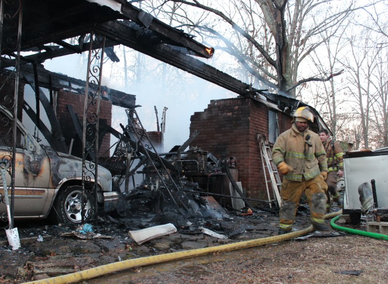 Firefighters work the scene of a fire that gutted a home on Fairfield Drive outside Sherwood Monday morning.