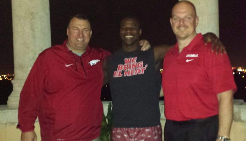 Arkansas defensive end commitment Anthony Brown poses with Coach Bret Bielema and defensive line and specialists coach Rory Segrest during Monday's in-home visit. 