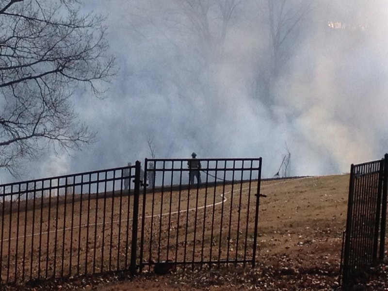 Fire broke out Tuesday at the base of a wooded ravine off North Summit Drive in Rogers. 