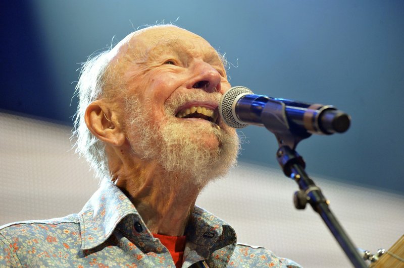 This Sept. 21, 2013, file photo shows Pete Seeger performing on stage during the Farm Aid 2013 concert at Saratoga Performing Arts Center in Saratoga Springs, N.Y. The American troubadour, folk singer and activist Seeger died Monday, Jan. 27, 2014, at age 94. 