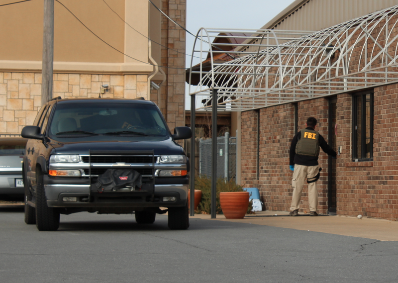 An FBI official walks into one of the Rogers Photo Archive buildings in North Little Rock Tuesday.