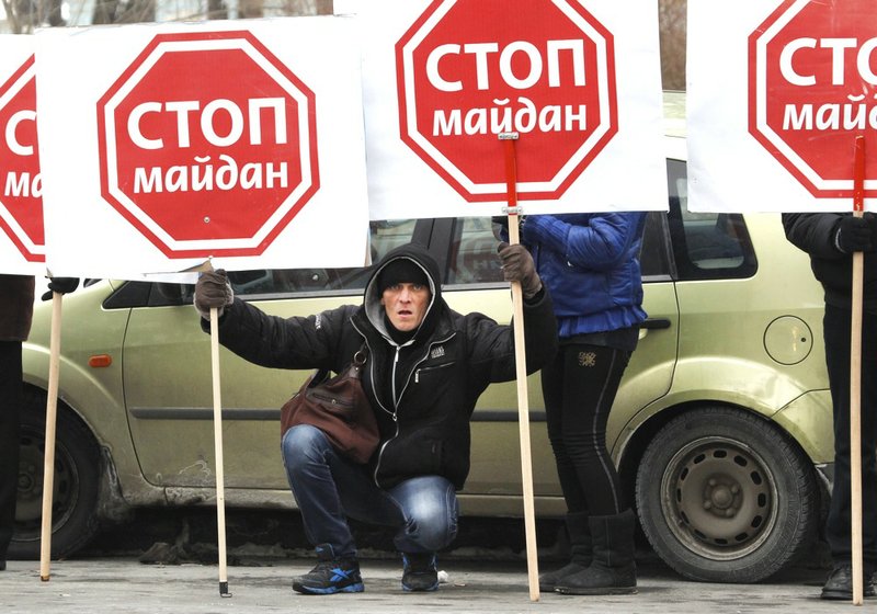 Supporters of President Viktor Yanukovych rally in central Kiev, Ukraine, on Tuesday, Jan. 28, 2014. The prime minister of protest-torn Ukraine submitted his resignation on Tuesday, saying he hoped the move would help bring peaceful resolution to the crisis that has gripped the country for two months. Mykola Azarov's resignation would remove one of the figures most despised by the opposition. It came as the parliament opened a special session that is expected to repeal harsh anti-protest laws that were imposed this month. Those laws set off the police-protester clashes in which at least three protesters died. The placards read: "Stop Maidan". 