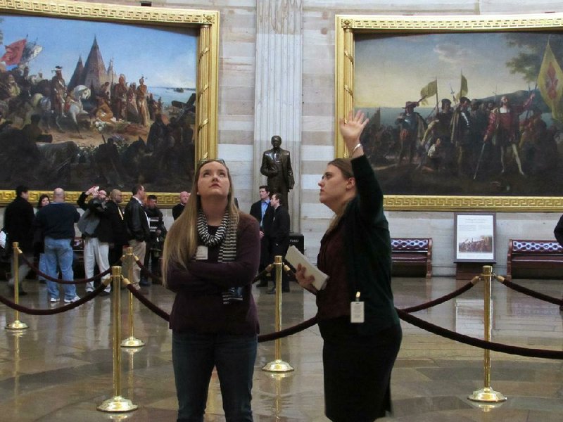 Beebe High School senior Jesse Kloss (left) looks at frescoes in the U.S. Capitol rotunda Monday during a tour led by intern Emily Goldberger. Kloss won an essay contest and a trip to Washington for the State of the Union address, courtesy of U.S. Rep. Tim Griffin, R-Little Rock. 