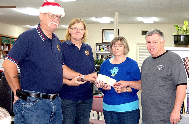 Submitted Photo The Decatur public library recently received a $600 donation from American Legion Post 100. Bill Freeman (left) and Barbara Aquini (commander of Post 100) presented the check to Karen Jones (librarian) and Dave Cook. The donation will be used to fund the senior gathering program at the library.