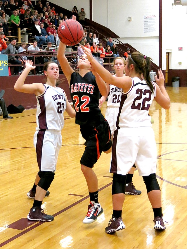 Photo by Randy Moll Gravette s Samantha Pruitt attempts a shot under the basket, surrounded by Gentry players Jordan Olds (#23), Aspen Cripps (#22) and Mallory Morris (#20).