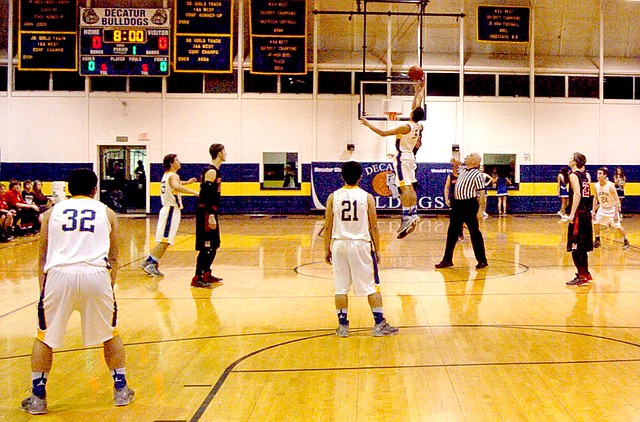 Photo by Mike Eckels During the opening tip-off of the Decatur/Magazine match-up Jan. 20, Mario Urguidi (#5) clearly out-jumps his opponent. Urquidi s athletic abilities and strong love of the game pushes him to achieve his final goal, victory.