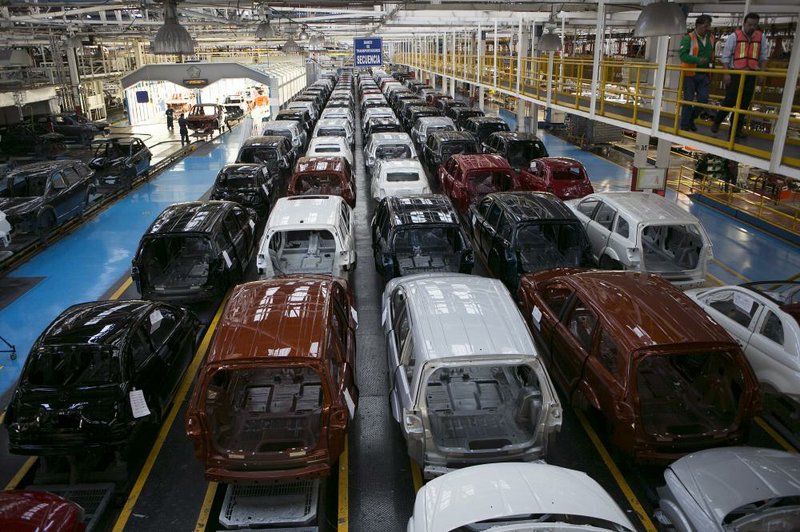 Fiat 500 and Dodge Journey vehicles sit on the production line after being painted at Chrysler Group LLC’s assembly plant in Toluca, Mexico, in November. Fiat’s board of directors agreed Wednesday to call the new combined company Fiat Chrysler Automobiles NV. 