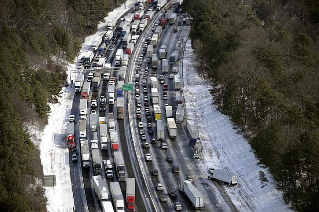 Traffic backs up Wednesday on icy Interstate 285 north of Atlanta. Georgia Gov. Nathan Deal said National Guard vehicles were taking aid to motorists stranded on the city’s snarled freeway system. 
