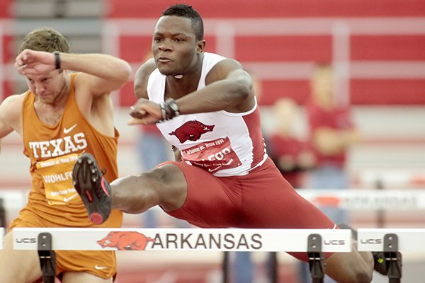 Arkansas freshman Omar McLeod competes in the 60-meter hurdles during a dual meet against Texas on Friday, Jan. 17, 2014, at the Randal Tyson Track Center in Fayetteville.