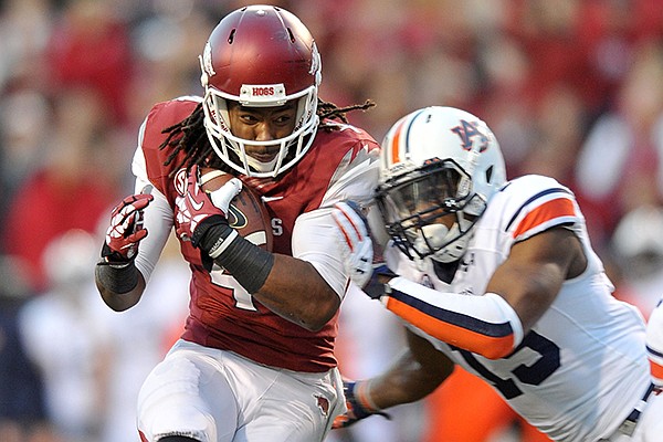 Arkansas receiver Keon Hatcher is taken down by Auburn defender Ryan White as he makes a catch inside the 5 yard line during the second quarter of a Nov. 2, 2013 game at Razorback Stadium in Fayetteville.