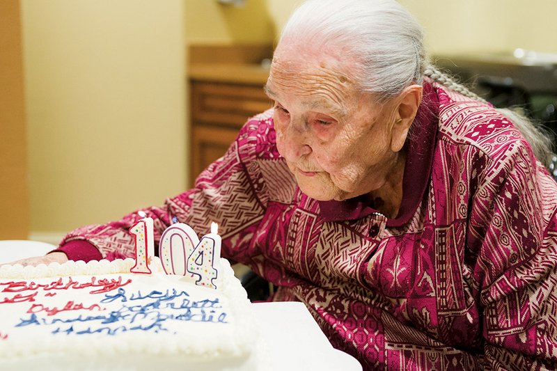 Viola “Dutch” Cowling blows out the candles on her birthday cake at her 104th birthday party Jan. 25 at the Mount Carmel Community senior living center in Bryant. Her party was held on a Saturday, three days before her actual birthday, so multiple generations of her family could attend.